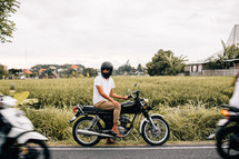 man sitting on a motorcycle 