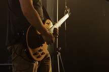 Electric guitar being played on stage during a concert, gig and band photograph
