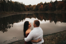 couple standing in front of a pond 