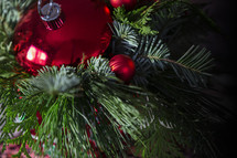 red Christmas ornament in greenery 