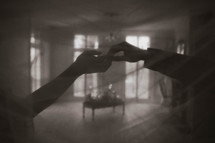 a black and white photo of a two hands being held