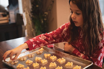 Little girl decorating Christmas cookies
