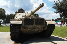 A military grade armored tank rests on display during peacetime to remind us of wartime and previous wars that have been fought to bring peace to the world using military force. 