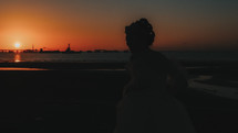 silhouette of a bride on a beach at sunset 