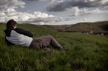 a man lying in a field of grass