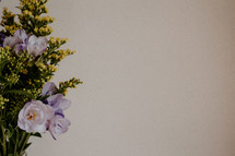 Purple and yellow flower bouquet on white background