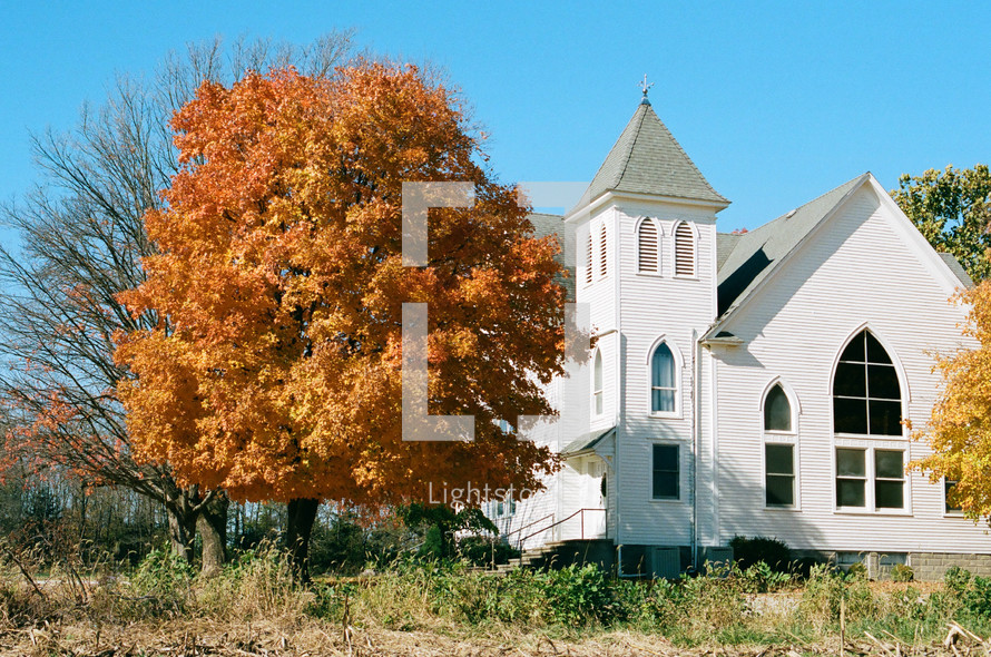 small white church in fall 