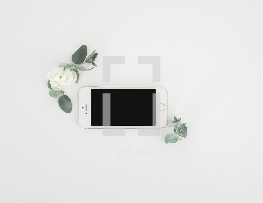cellphone and flowers on white background 