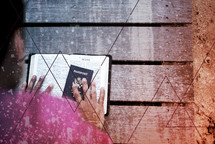 man looking at his passport and Bible 