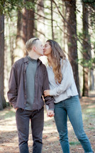 couple kissing in the woods 