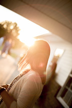 woman standing outdoors in bright sunlight 