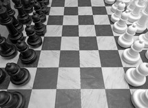 A black and white image of a huge chess board with chess pieces in black and white on a checkered black and white chess board that takes up about 10 feet of floor space symbolizing the game of life, life and death, good and evil, risk and chance and strategy and planning. All the things that make up life and thinking through moves that we make that can affect our spiritual and physical as well as mental well being. 

I saw this huge chess board at a local shopping mall and it just captured my imagination and had to photograph it. It reminded me of the game of life and the choices we have to make to affect our future as well as the spiritual battle between good and evil that we deal with in this life and the next. 
