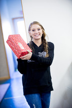 smiling girl holding a Christmas gift 
