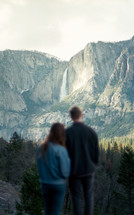 couple viewing a distant waterfall 