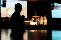 a silhouette of a child during a worship service 