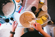 woman making pancake batter in a kitchen 