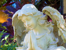 Distressed angel statue in a garden