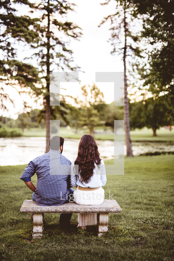 a couple sitting on a bench together 
