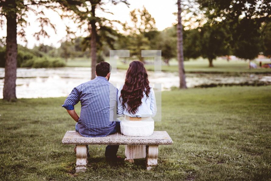 a couple sitting together on a bench 