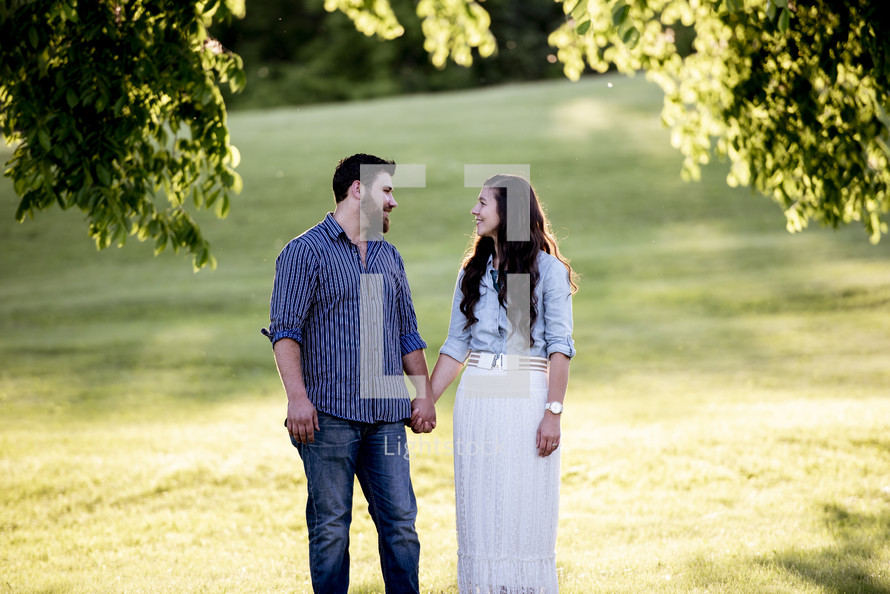 portrait of a couple holding hands outdoors 