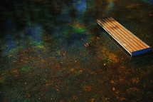 Abandoned park bench overflowed