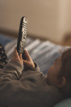 toddler holding a remote control 