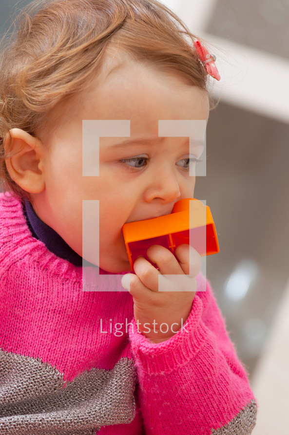 toddler girl playing with blocks 