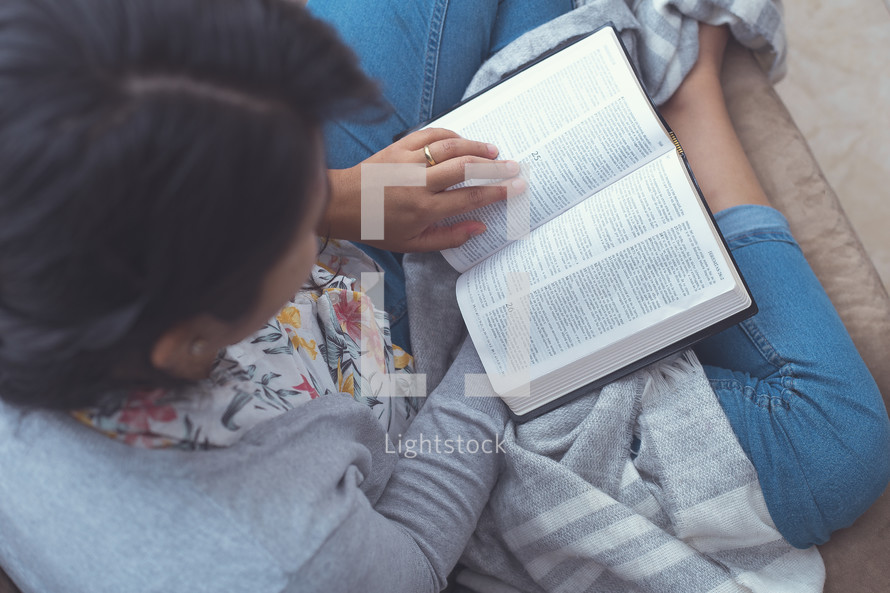 a woman reading a Bible in her lap 