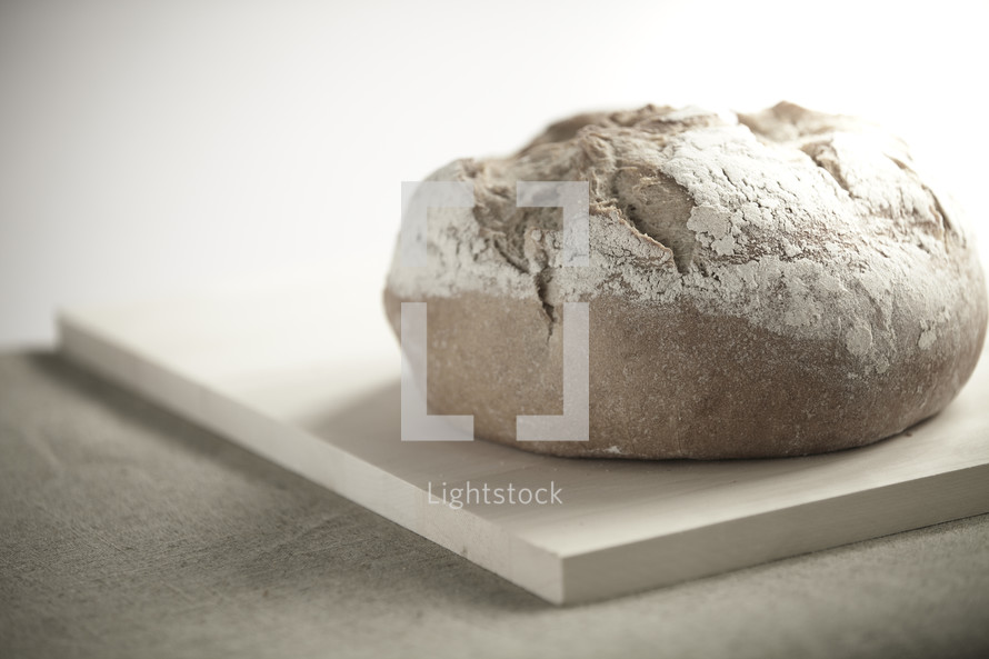 A loaf of bread sitting on a cutting board
