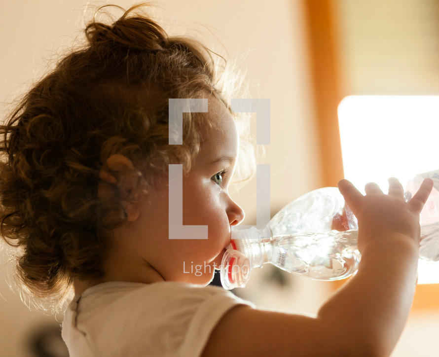a toddler drinking a water bottle 