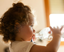 a toddler drinking a water bottle 