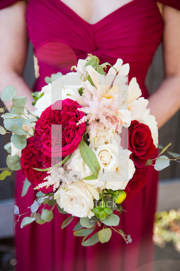 bridesmaid holding a bouquet of flowers 