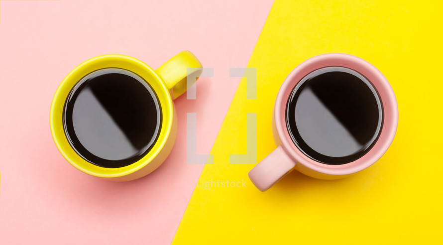coffee cups on pink and yellow paper 