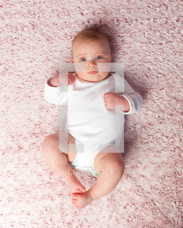 infant rug on a pink rug 