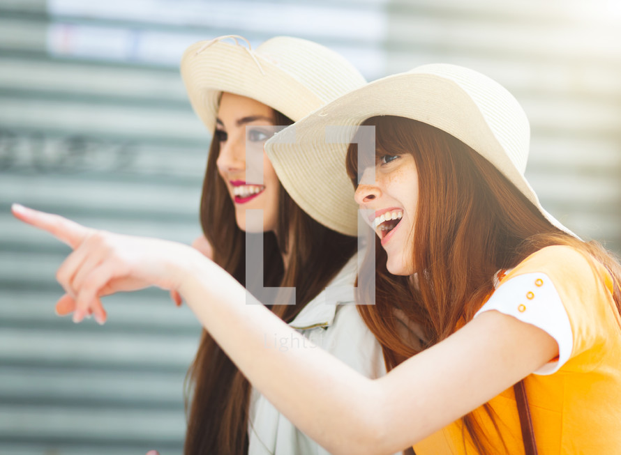 Two young tourists with straw hats