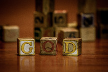 pile of wood blocks on a playroom floor and the word God 