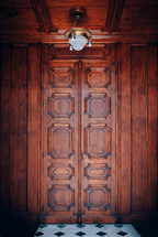 lamp on a wood ceiling and wood door 