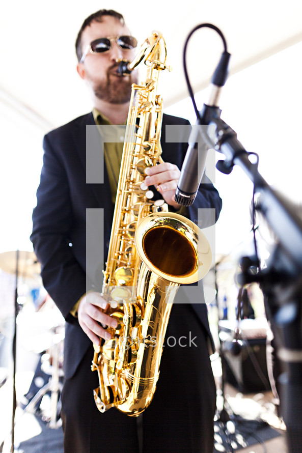 A musician playing a tenor saxophone.