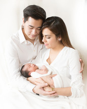 Couple holding their newborn infant.