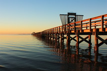 Gulf pier on the ocean at sunset.