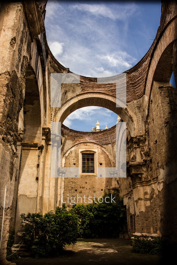arches and blue sky in a Guatemala cathedrals courtyard 