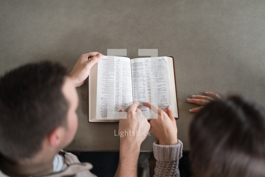a couple studying a Bible together 