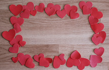 red hearts border on wood 