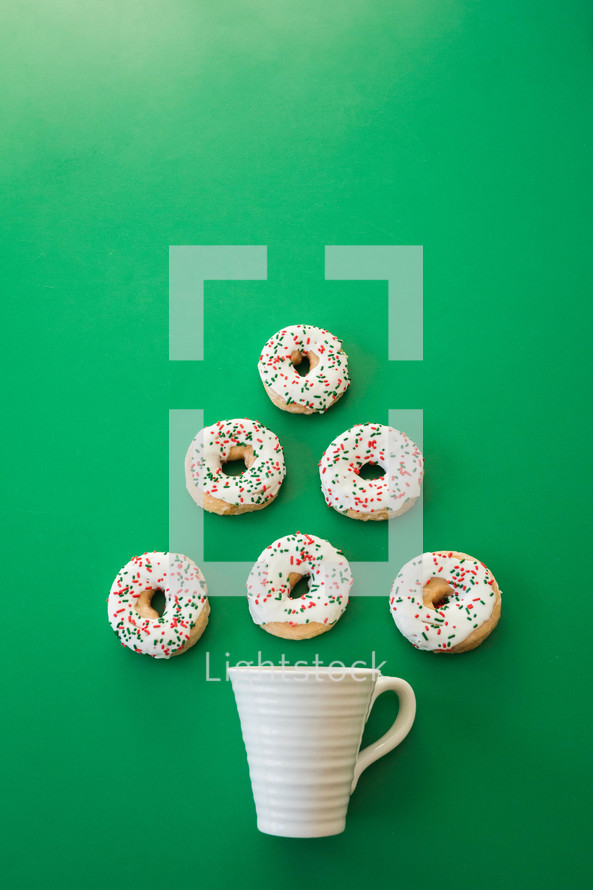 coffee mug and Christmas donuts in the shape of a Christmas tree