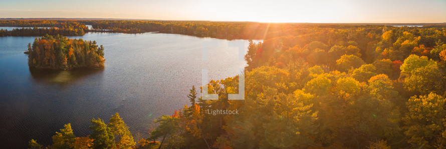 aerial view over lake and swamp in fall at sunset 