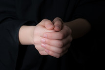 A child's clasped hands.