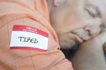 tired name tag - man sleeping 