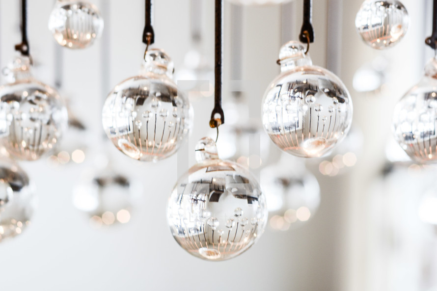 glass balls hanging on string at a wedding 