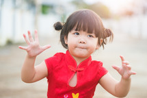 Little asian girl pray and wishing you a happy Chinese New Year