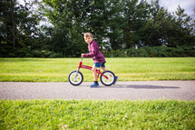 a boy on a training bicycle 